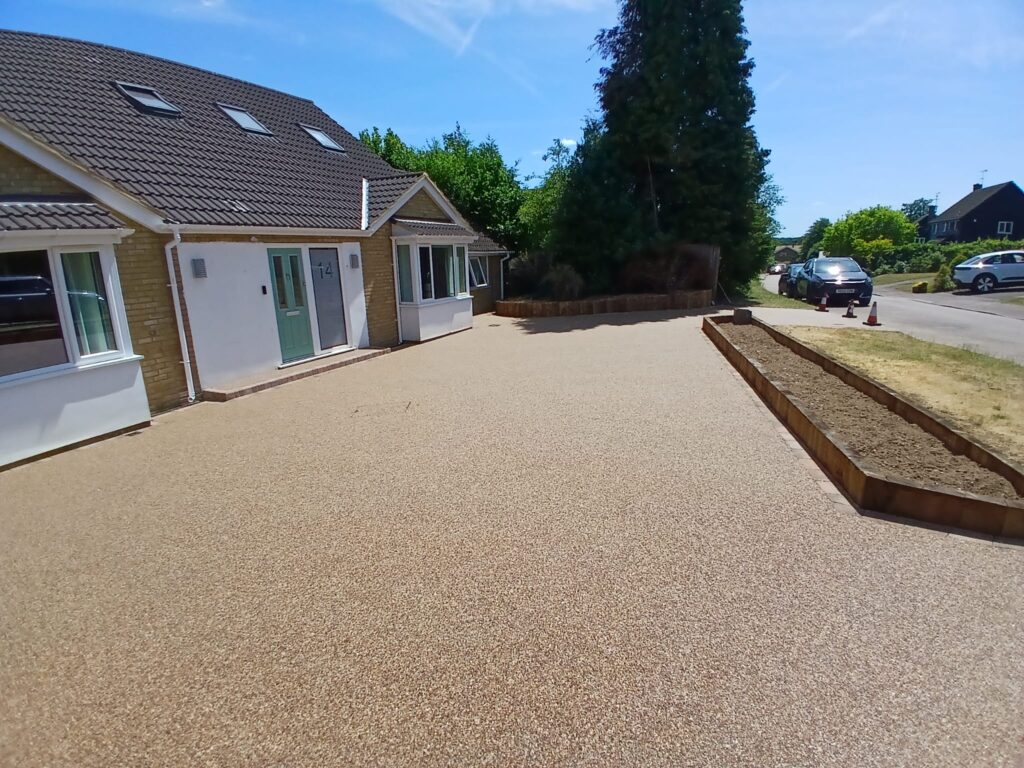 A completed resin-bound driveway with new sleeper walls in Knebworth